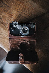black and gray camera and brown case thumbnail