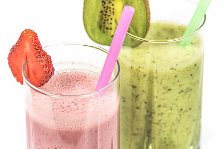 Strawberry and Kiwi milkshake on drinking glass and straws thumbnail