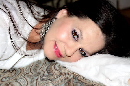 woman lying on textile while smiling thumbnail