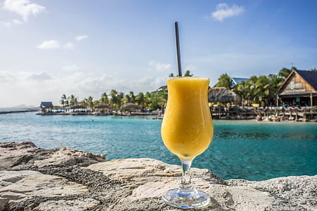 clear drinking glass near body of water thumbnail