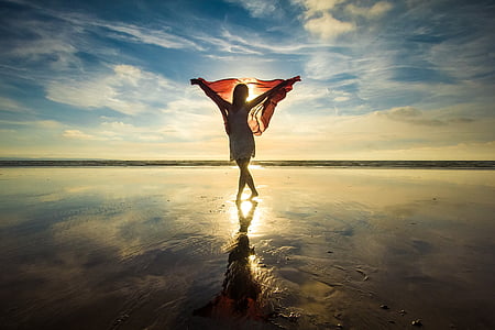 woman standing at the beach during day thumbnail