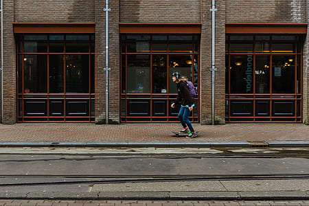 man skating beside building at daytime thumbnail