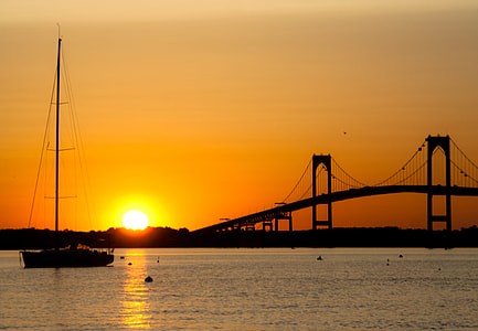 silhouette of boat and arch bridge at sunset thumbnail