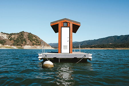white and brown room on body of water at daytime thumbnail