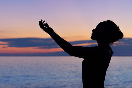 silhouette of a woman raising hands thumbnail