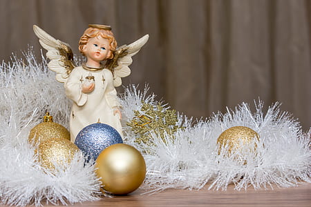 cherub figurine beside assorted-color baubles thumbnail