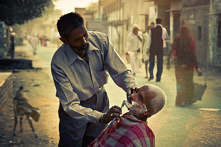 selective focus photography of man shaving beard thumbnail