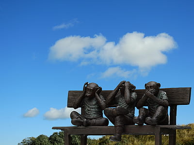 three wise monkeys sitting on bench statues thumbnail