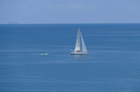 white sailboat on body of water thumbnail