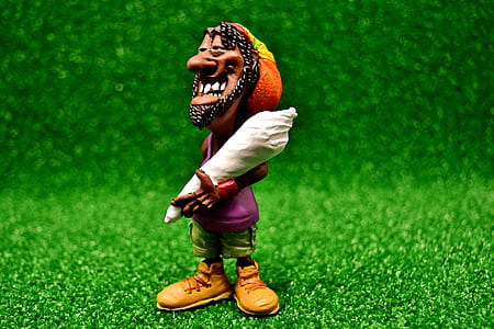 rasta man holding tobacco figurine thumbnail