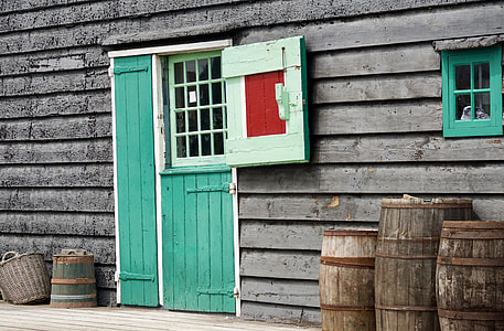brown wooden house with green door thumbnail