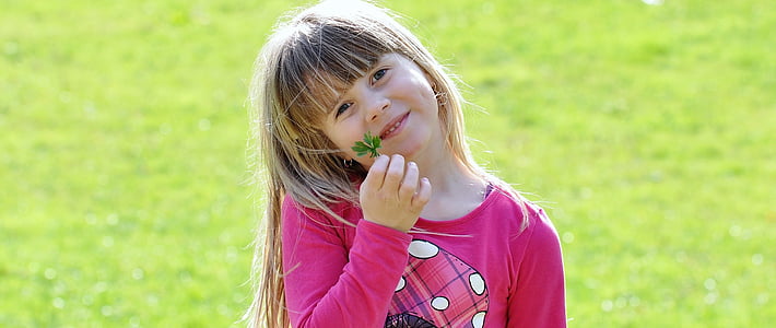 girl holding green leaves thumbnail