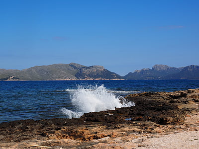 blue and white body of water splashing on reef during daytime thumbnail