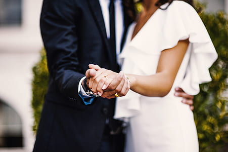shallow focus photography of man and woman holding hands while dancing together thumbnail