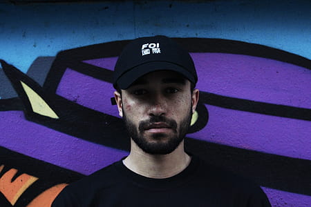 Man Wearing Black Cap and Black Crew-neck Top thumbnail