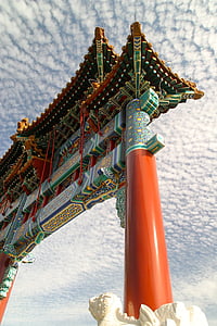 low angle photo of orange and green gate under white clouds thumbnail
