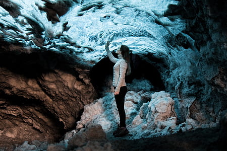 woman wearing white long-sleeved top touching white boulder thumbnail