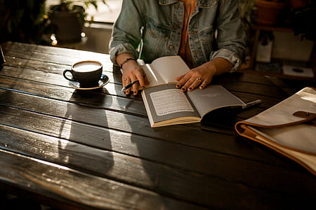 woman reading a book while having a coffee thumbnail