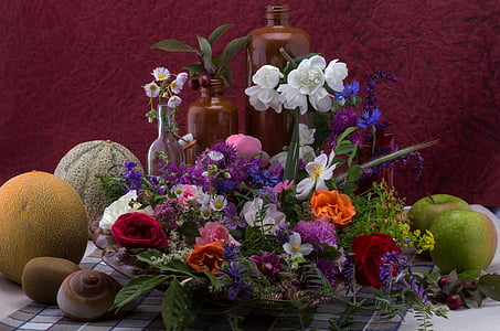white and red petaled flowers centerpiece near fruits thumbnail