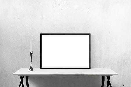 rectangular white board with black wooden frame on top of white wooden console table thumbnail