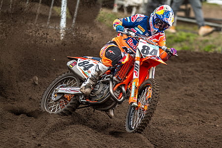 man riding orange dirt bike thumbnail