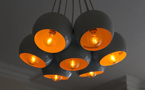 lit grey and orange pendant lamps thumbnail