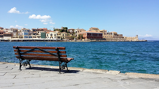 parked bench near seat surrounded by buildings at daytime thumbnail