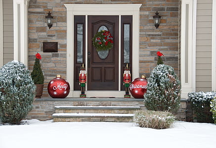 house with Christmas decorations outside the door thumbnail