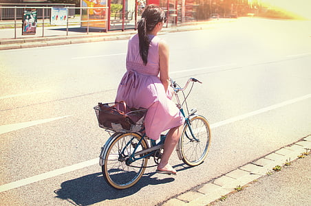 woman driving city bicycle on road thumbnail
