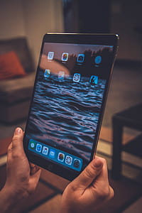 person holding space gray iPad thumbnail