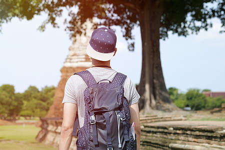 Shallow Focus Photo of Person Wearing Black Flat Brim Cap thumbnail