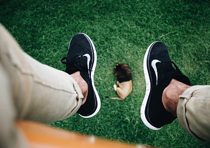 person wearing pair of black Nike sneakers thumbnail