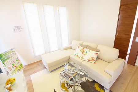 white fabric divan sofa beside the window thumbnail