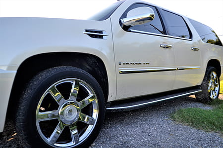 white Cadillac Escalade SUV parked on open field thumbnail