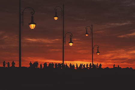 silhouette of people during orange sunset thumbnail
