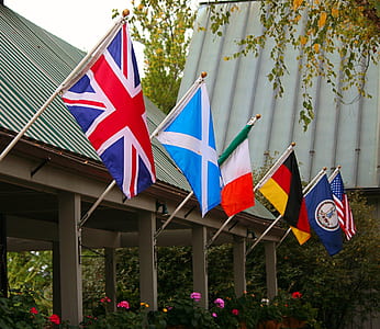 six assorted flags near roof at daytime thumbnail