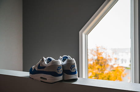 pair of white-and-blue Nike Air shoes thumbnail