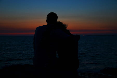 silhouette of man and woman during golden hour thumbnail