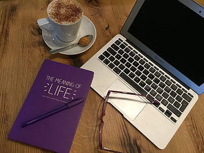 MacBook Air beside white ceramic mug on white saucer thumbnail