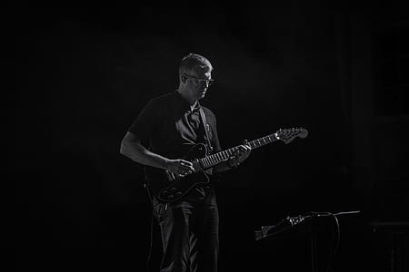 grayscale photo of man playing electric guitar thumbnail
