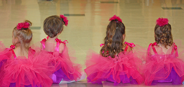 photo of four girls wearing pink ball gowns thumbnail