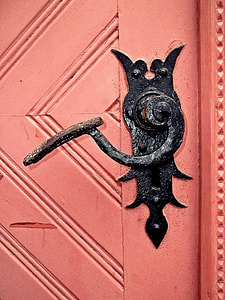 pink wooden door with black knob thumbnail