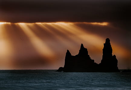 silhouette photo of a island during golden hour thumbnail