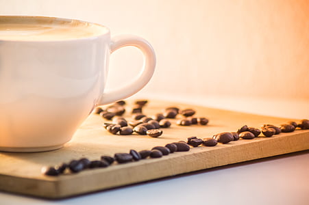 white ceramic mug on brown wooden board with beans thumbnail