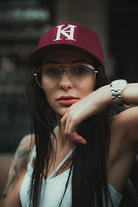 woman wearing red cap and white spaghetti strap top thumbnail