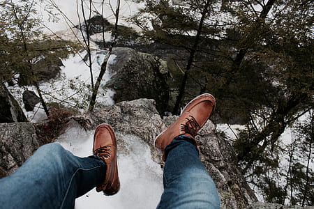 person sitting on cliff thumbnail