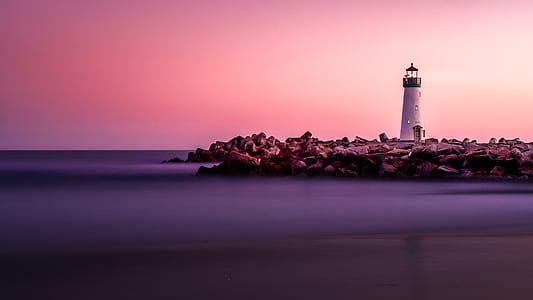 white lighthouse beside body of water thumbnail