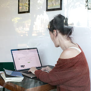 woman using laptop computer inside room thumbnail