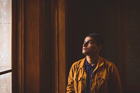 Photo of Man Looking Towards Window thumbnail