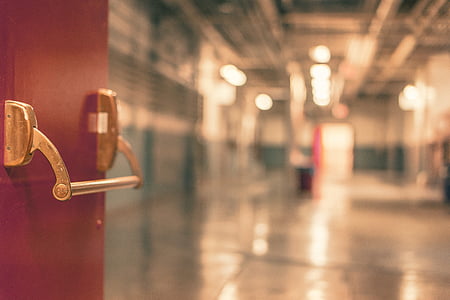shallow focus photography of red door with gold-colored door lever thumbnail